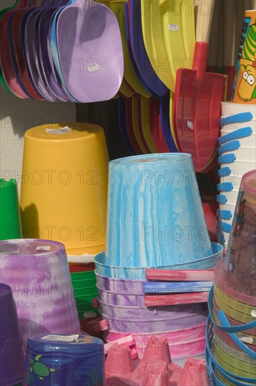 ENGLAND, Dorset, Lyme Regis, Buckets and spades for sale at a beach side shop.