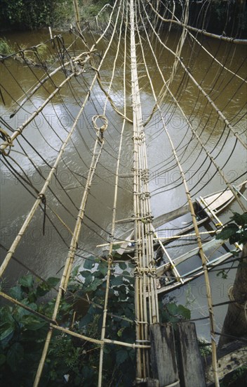 INDONESIA, Sulawesi, Napu Valley. Bamboo bridge over river.