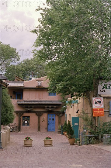 USA, Colorado, Taos Town, Street with flower tubs and traditional architecture