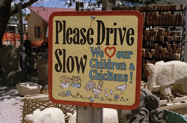 USA, New Mexico, Santa Fe, Road sign warning of children and chickens in the road