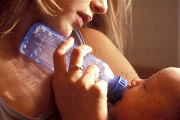 PEOPLE, Mother and Child, Mother bottle feeding her young baby