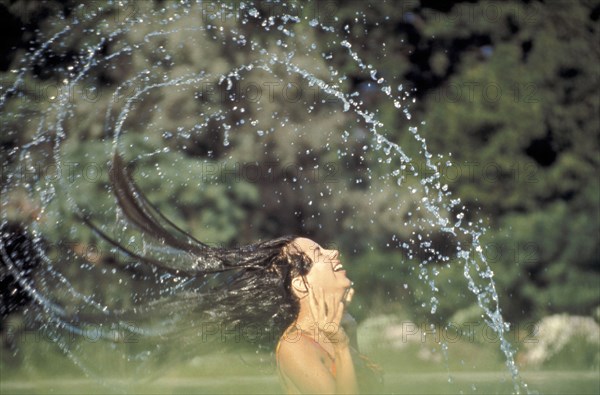 PEOPLE, Women, Woman in a swimming pool flings her wet hair over her head