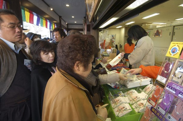 JAPAN, Honshu, Chiba , Narita San Temple. New Years Holiday worshippers buying Buddhist charms