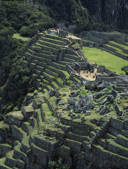 PERU, Cusco Department, Machu Picchu, View over the central plaza with main temple ruins and the walled terraces below
