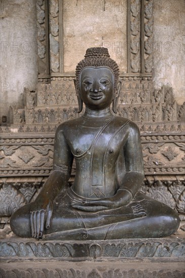 LAOS, Vientiane, Haw Pha Kaew Temple.  Seated Buddha figure.