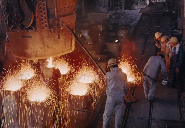 CHINA, Liaoning, Anshan, Interior of steel works with male workers.