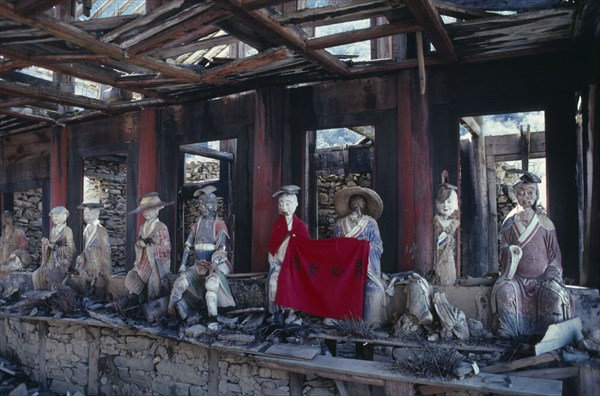 CHINA, Sichuan Province, Huanglong Valley, Yellow Dragon temple.  Dilapidated structure and damaged statues.