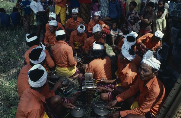 INDONESIA, Bali, Music, Gamelan orchestra playing at cremation ceremony.