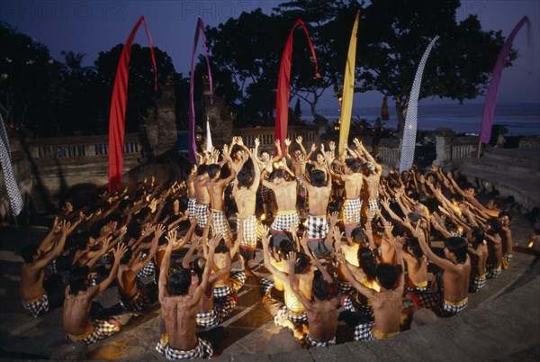 INDONESIA, Bali, Kechak dancers forming human mandala.  The Kechak dance tells the story of Prince Rama and his quest to rescue his wife Sita from the demon king Ravana.