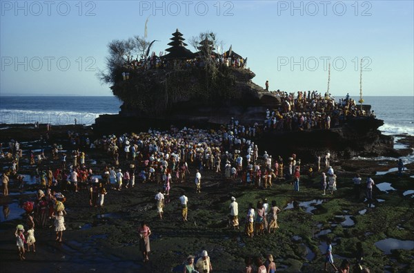 INDONESIA, Bali, Tanah Lot, Crowds gathered at Hindu temple for festival.