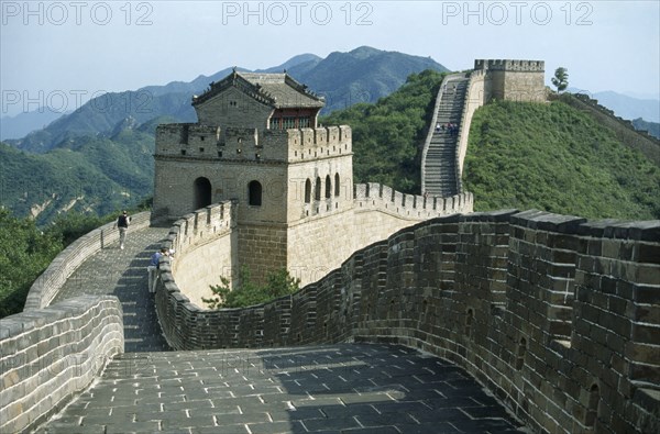 CHINA, Badaling, The Great Wall.  Few tourists on stretch of wall with gatehouse.