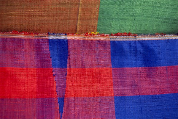 EGYPT, Nile Valley, Luxor, Detail of coloured woven textile for sale in the souq.