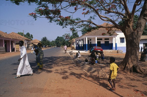 GUINEA BISSAU, San Domingos, Street scene with people and roadside vendor in town in the Casheu region.
