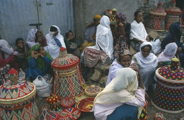 ETHIOPIA, Gonder, Women selling colourful woven baskets at market.