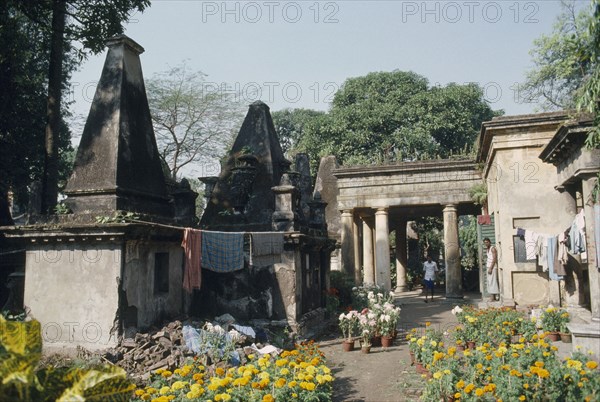 INDIA, West  Bengal, Calcutta, The British cemetery at South Park Street with laundry from resident families hanging up to dry.