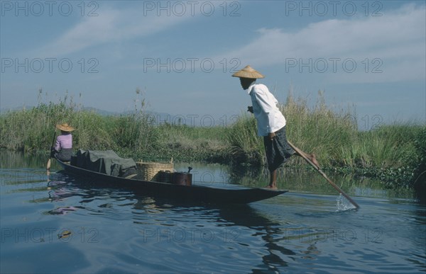 MYANMAR, Transport, Fishing boat rowed by oarsman using one leg.