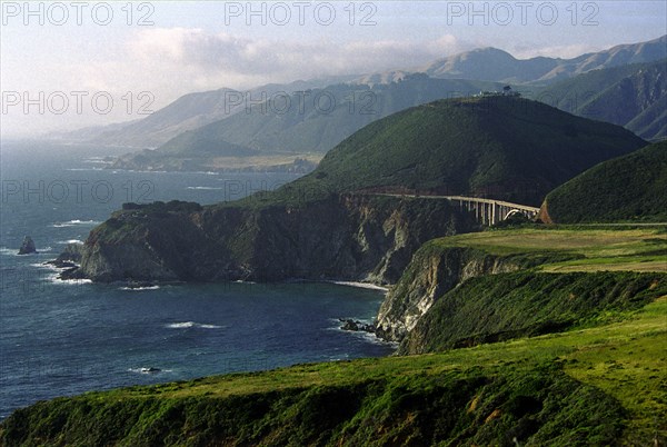 USA, California, Big Sur National Park, View along coastline that runs along Highway 1 with Bixby Bridge in the distance