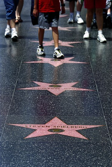USA, California, Los Angeles, Hollywood. Pink marble and bronze stars embedded into Hollywood Boulevard sidewalk aka Hollywood walk of Fame