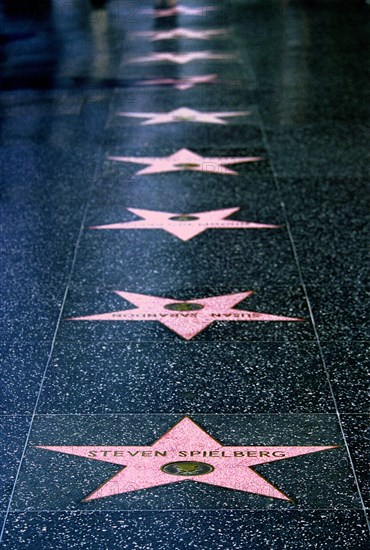 USA, California, Los Angeles, Hollywood. Pink marble and bronze stars embedded into Hollywood Boulevard sidewalk aka Hollywood walk of Fame