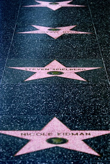 USA, California, Los Angeles, Hollywood. Pink marble and bronze stars embedded into Hollywood Boulevard sidewalk aka Hollywood walk of Fame