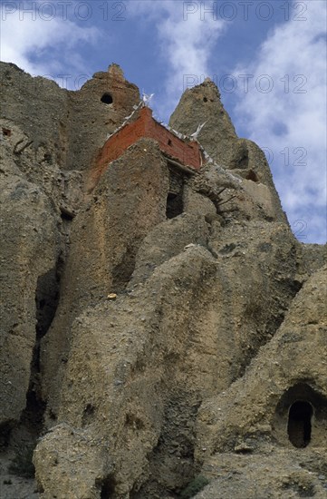 NEPAL, Mustang, Lori Gompa, "Cave monastery perched high on steep, eroded cliff face."