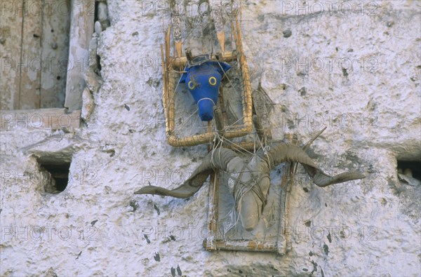 NEPAL, Mustang, Effigies fixed above the main entrance of a home to ward off evil spirits.