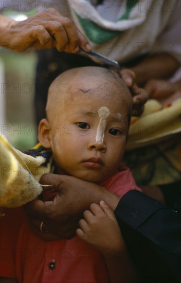 MYANMAR, Children, Ritual head shaving of initiate monk.