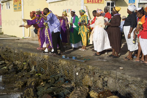 WEST INDIES, St Vincent & The Grenadines, Union Island, Baptist preacher and congregation in Clifton at Easter morning harbourside service for those lost at sea