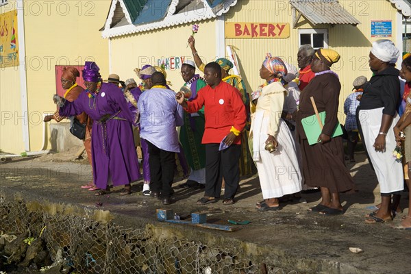 WEST INDIES, St Vincent & The Grenadines, Union Island, Baptist preacher and congregation in Clifton at Easter morning harbourside service for those lost at sea