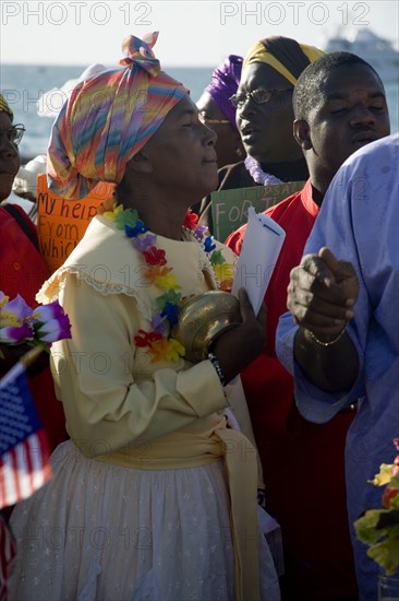 WEST INDIES, St Vincent & The Grenadines, Union Island, Woman amongst the Baptist congregation in Clifton at Easter morning harbourside service for those lost at sea