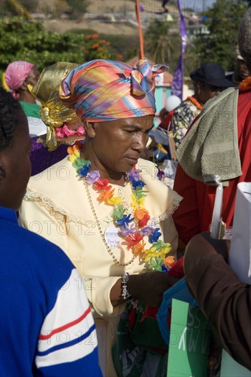 WEST INDIES, St Vincent & The Grenadines, Union Island, Woman amongst the Baptist congregation in Clifton at Easter morning harbourside service for those lost at sea