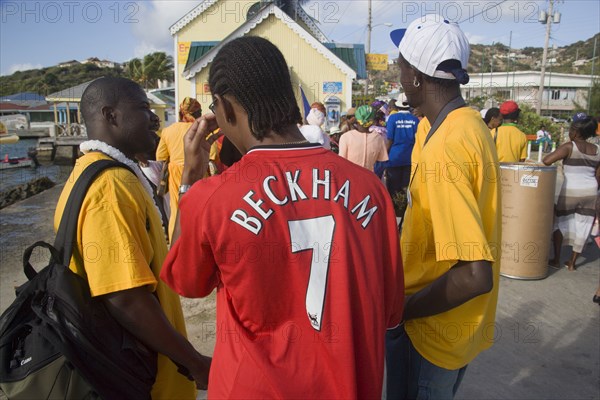 WEST INDIES, St Vincent & The Grenadines, Union Island, Men of the Baptist congregation in Clifton at Easter morning harbourside service for those lost at sea with one wearing a Beckham football shirt