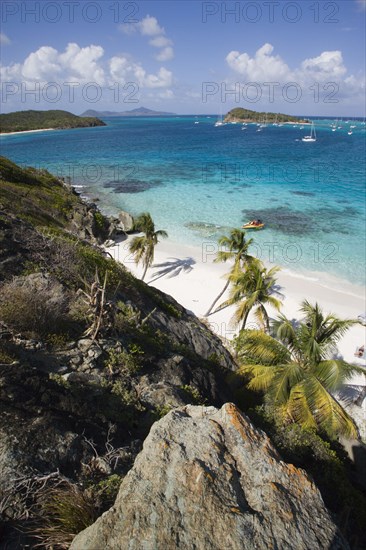 WEST INDIES, St Vincent & The Grenadines, Tobago Cays, View over the beach of Jamesby Island and moored yachts towards Canouan on the horizon