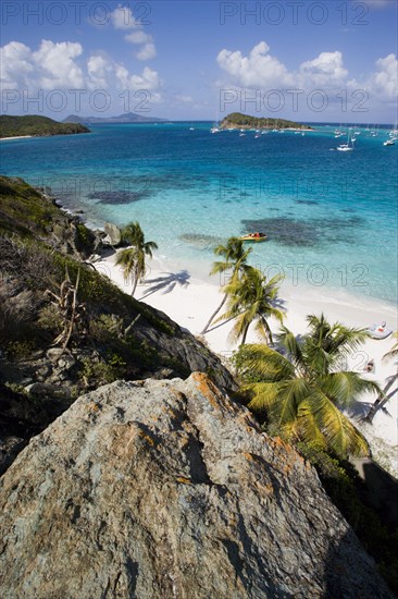 WEST INDIES, St Vincent & The Grenadines, Tobago Cays, View over the beach of Jamesby Island and moored yachts towards Canouan on the horizon