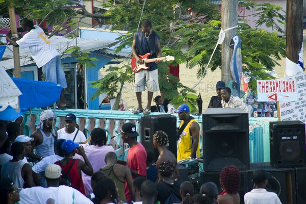 WEST INDIES, St Vincent & The Grenadines, Union Island, Guitarist and sound system at Easterval Easter Carnival in Clifton