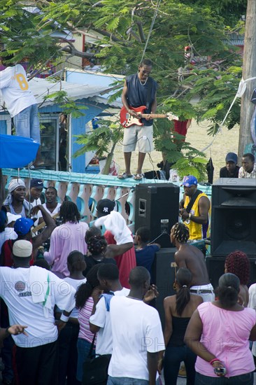 WEST INDIES, St Vincent & The Grenadines, Union Island, Guitarist and sound system at Easterval Easter Carnival in Clifton