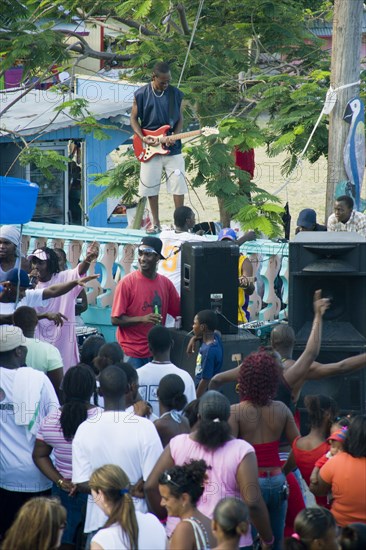 WEST INDIES, St Vincent & The Grenadines, Union Island, Guitarist and sound system at Easterval Easter Carnival in Clifton