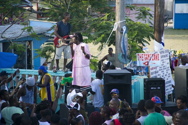 WEST INDIES, St Vincent & The Grenadines, Union Island, Singer and guitarist with sound system at Easterval Easter Carnival in Clifton