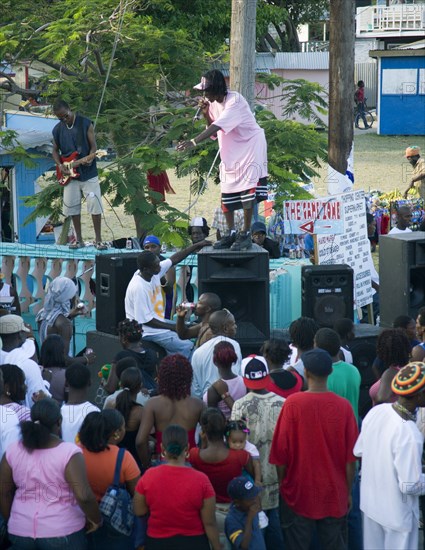 WEST INDIES, St Vincent & The Grenadines, Union Island, Singer and guitarist with sound system at Easterval Easter Carnival in Clifton