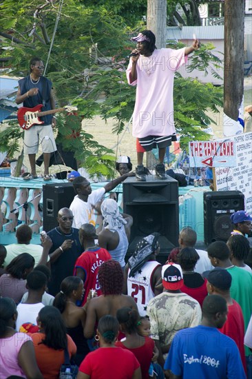 WEST INDIES, St Vincent & The Grenadines, Union Island, Singer and guitarist with sound system at Easterval Easter Carnival in Clifton