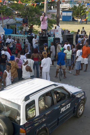 WEST INDIES, St Vincent & The Grenadines, Union Island, Singer singing to and about police at Easterval Easter Carnival in Clifton