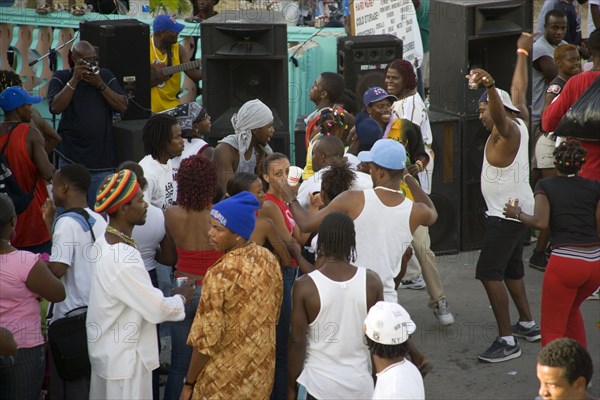 WEST INDIES, St Vincent & The Grenadines, Union Island, People dancing beside sound system at Easterval Easter Carnival in Clifton