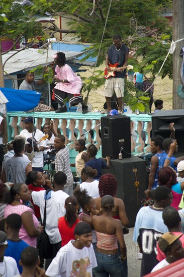 WEST INDIES, St Vincent & The Grenadines, Union Island, Singer and guitarist by sound system at Easterval Easter Carnival in Clifton