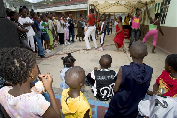 WEST INDIES, St Vincent & The Grenadines, Union Island, Children watching other children dancing to a sound system at the Easterval Easter Carnival in Clifton