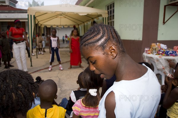 WEST INDIES, St Vincent & The Grenadines, Union Island, Children watching other children dancing to a sound system at the Easterval Easter Carnival in Clifton