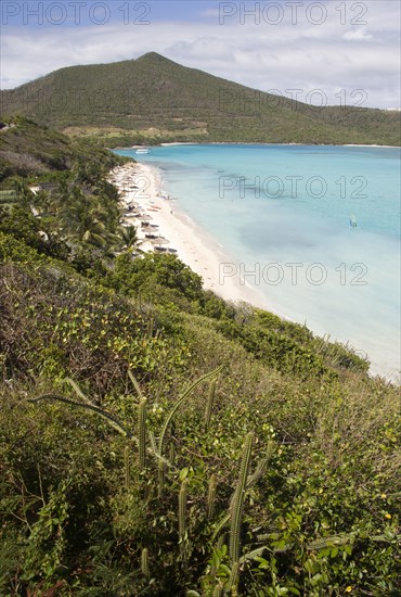 WEST INDIES, St Vincent & The Grenadines, Canouan, Godahl beach at Raffles Resort with Mount Royal on the horizon