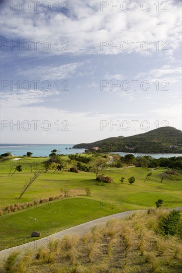 WEST INDIES, St Vincent & The Grenadines, Canouan, Raffles Resort showing part of the Trump International Golf course beside Carenage Bay