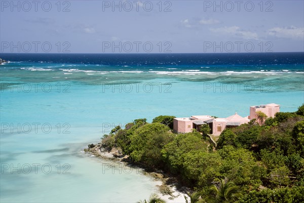 WEST INDIES, St Vincent & The Grenadines, Canouan, Pink villa on the headland of Carenage bay at Raffles Resort