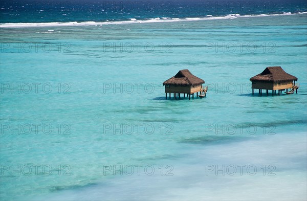 WEST INDIES, St Vincent & The Grenadines, Canouan, Offshore treatment rooms of the Amrita Spa off Godahl Beach at Raffles Resort with the coral reef beyond