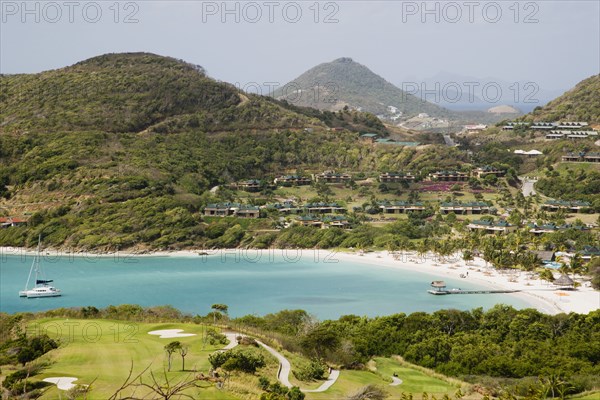 WEST INDIES, St Vincent & The Grenadines, Canouan, Jambu Beach at Raffles Resort and Trump International Golf Course with Union Island in the distance